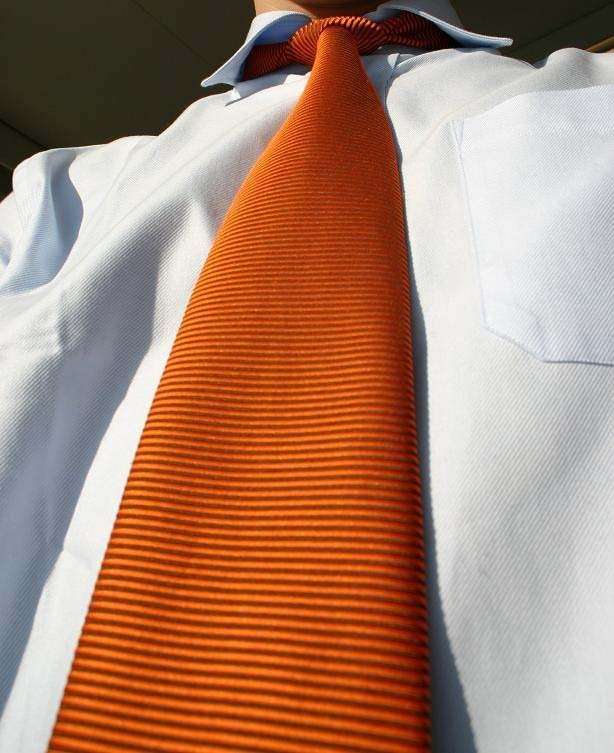 Camisa con una corbata naranja.